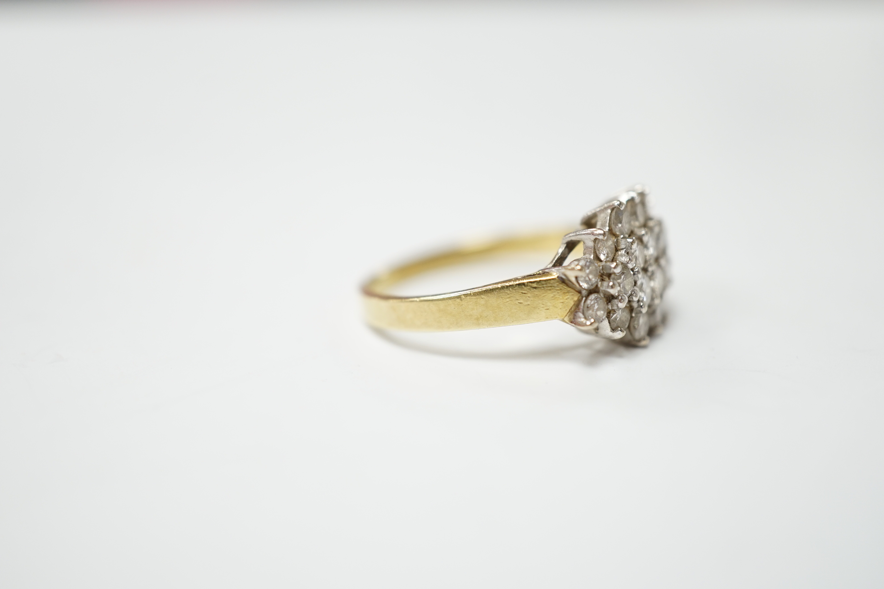A modern 18ct gold and diamond cluster set dress ring, size P, gross weight 4.4 grams.